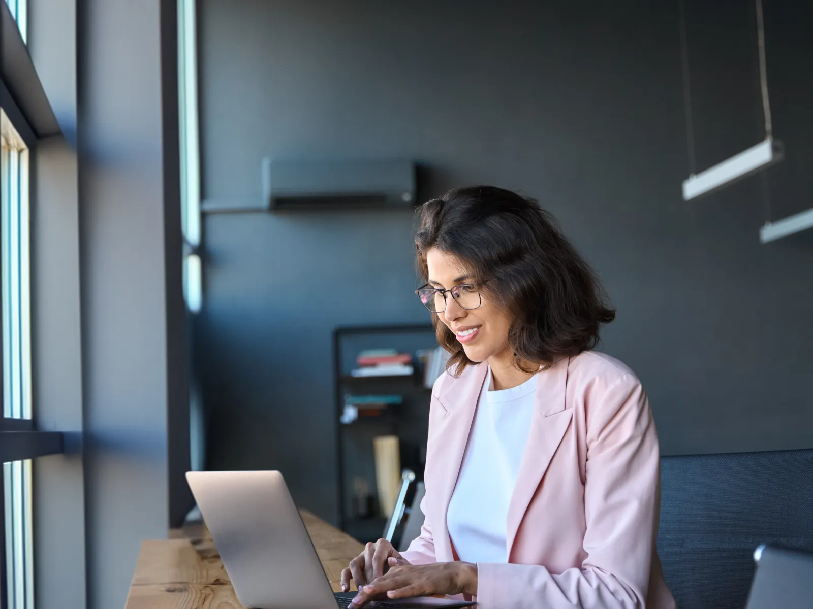 a person sitting at a table using a laptop