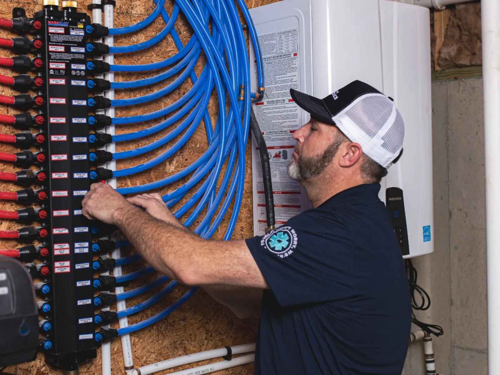 A plumbing expert working on a water heater system