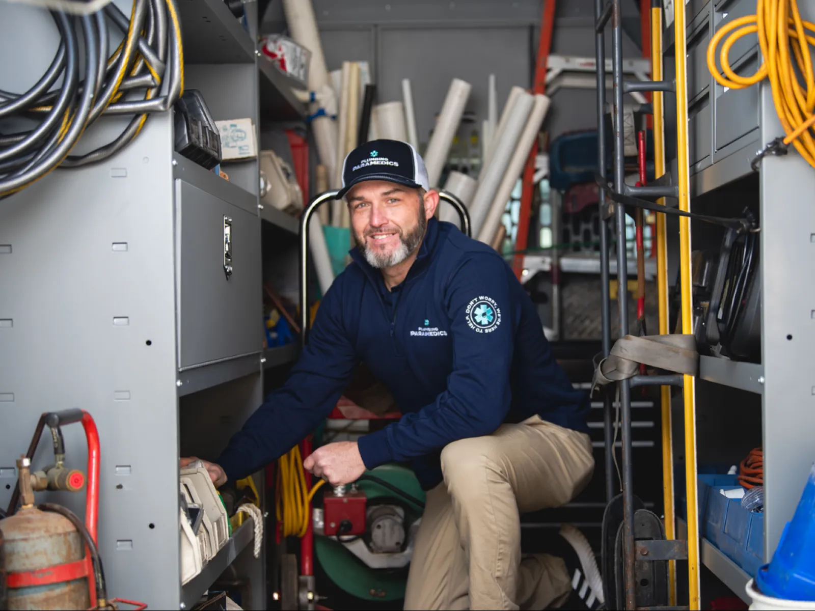 A professional man organizing tools in a service van, showcasing maintenance equipment.