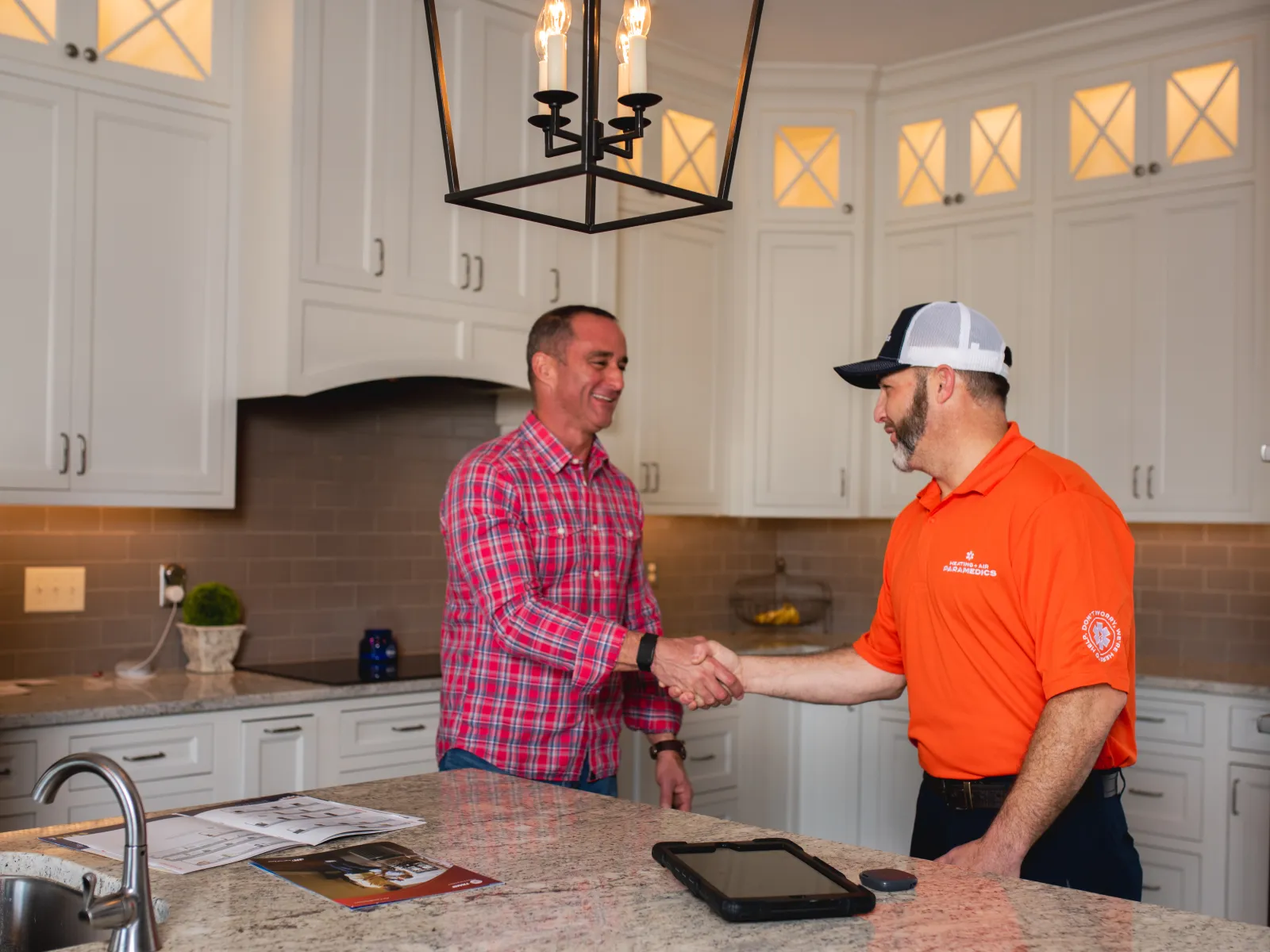Heating + Air Paramedics Raleigh technician shaking hands with a new HVAC customer in North Carolina