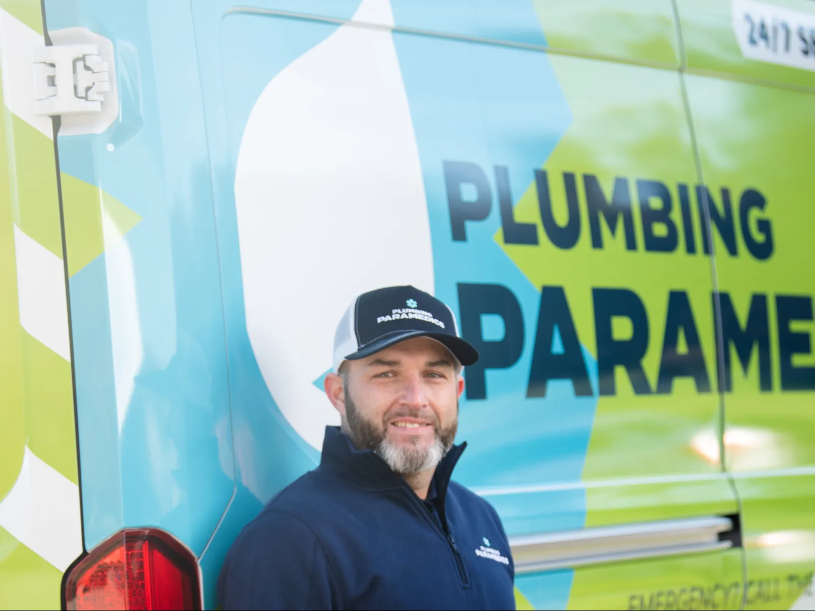 Plumbing Paramedics Crown Point technician posing with team truck