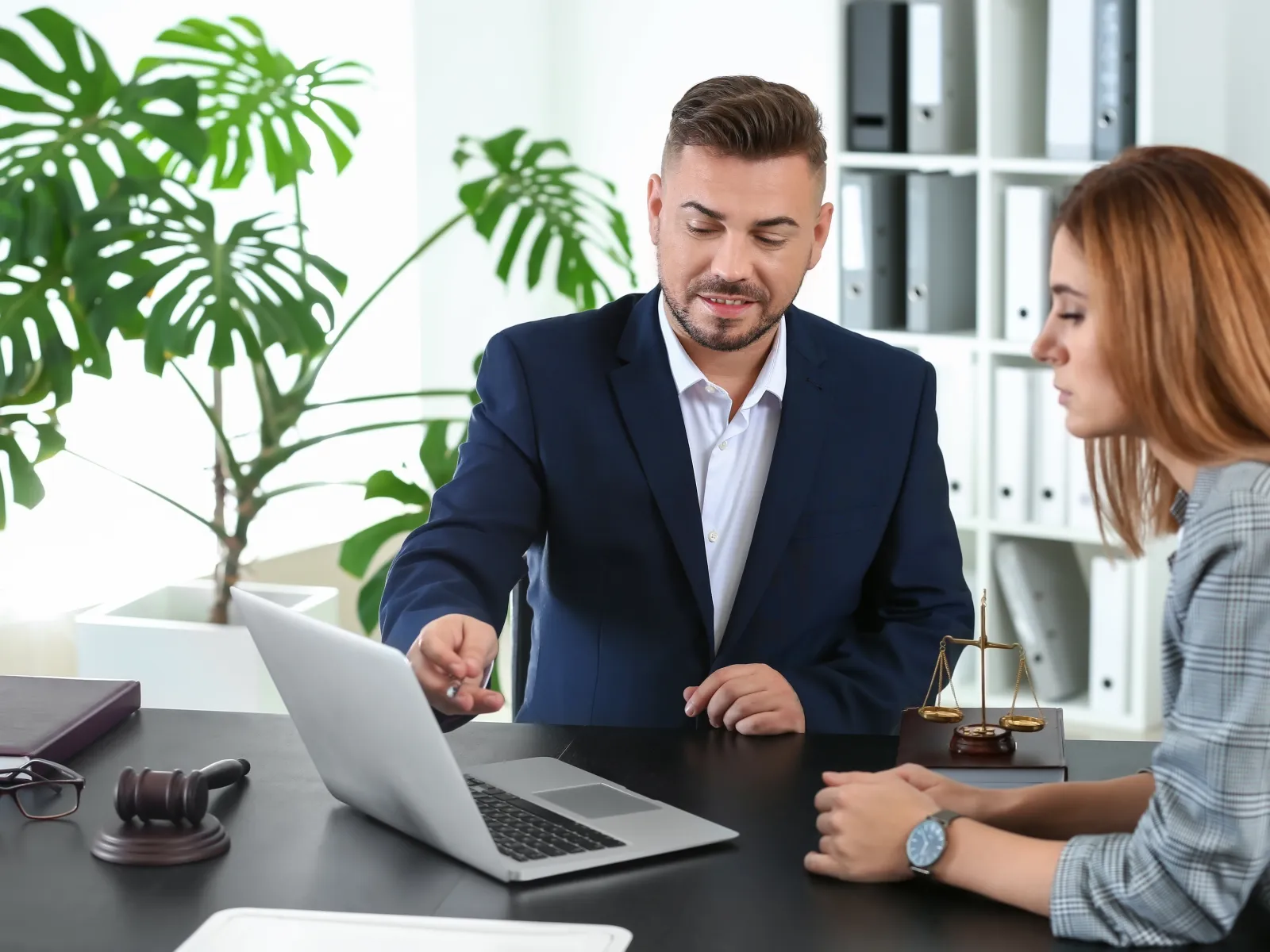 a man and a woman looking at a laptop