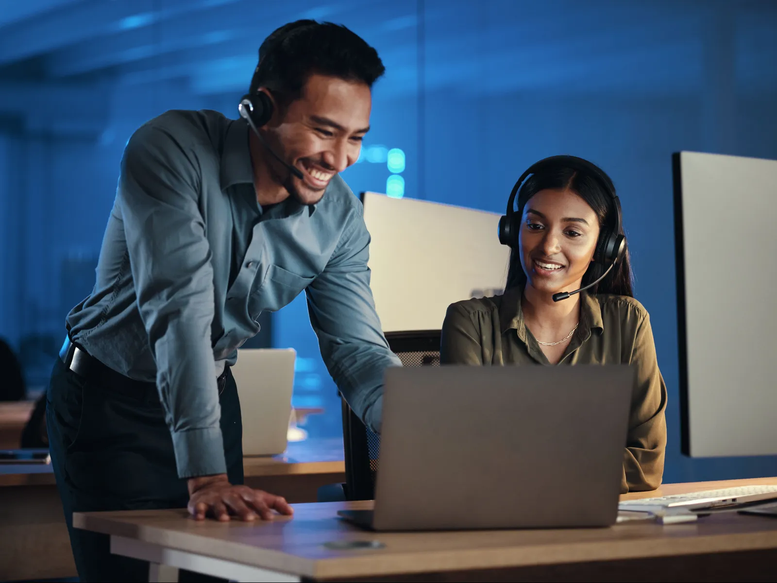 a man and a woman looking at a laptop