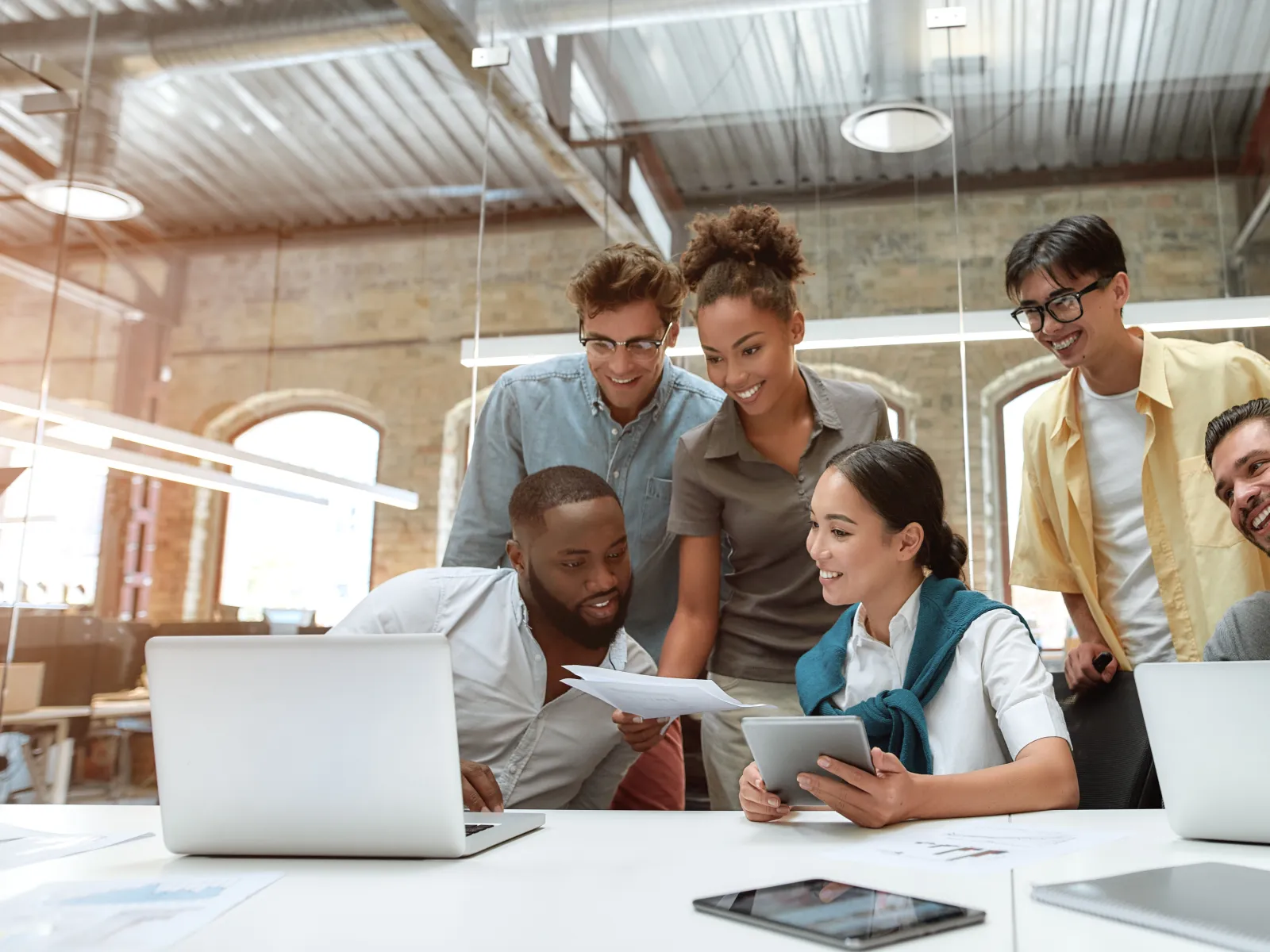 a group of people looking at a laptop