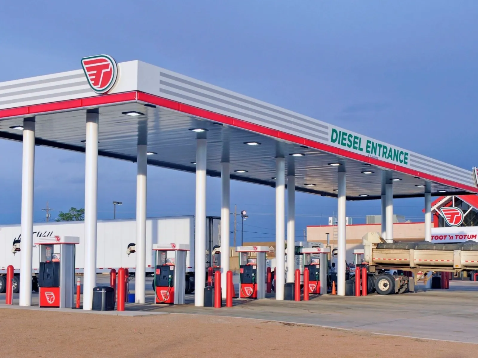 a gas station with a truck parked in front