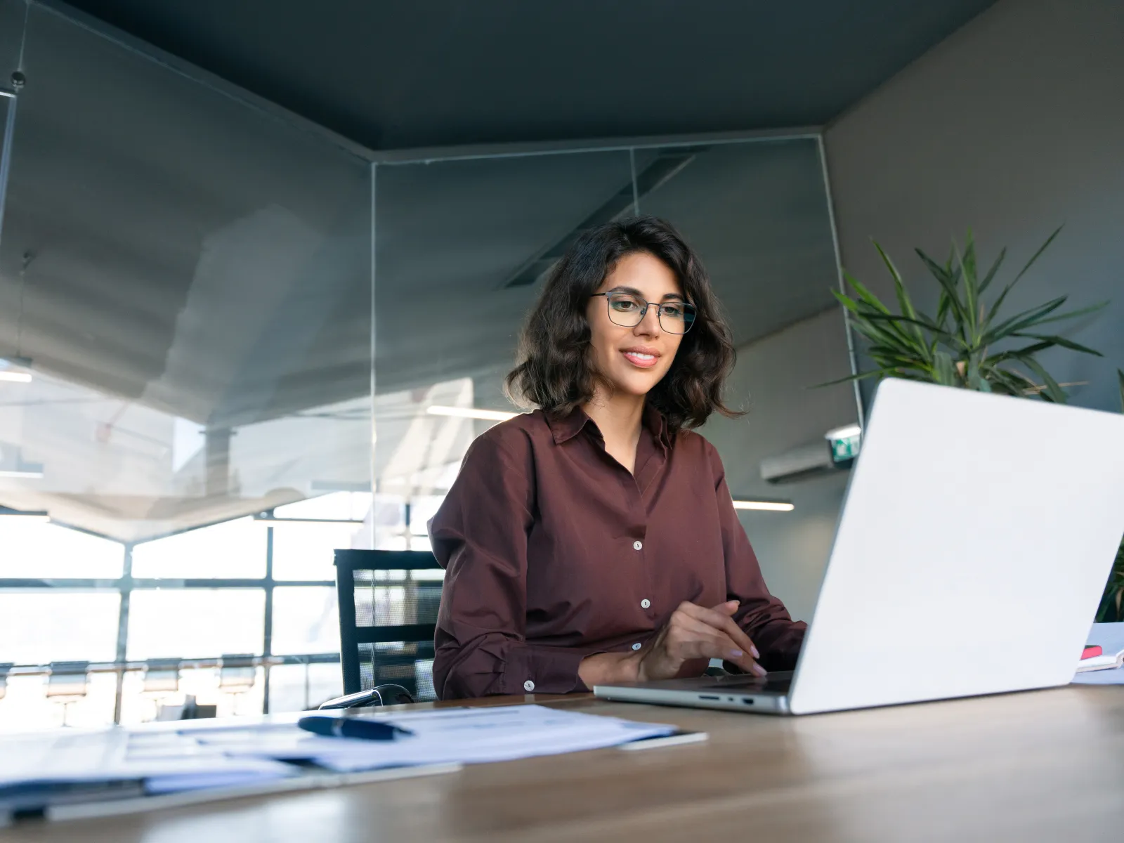 a person sitting at a desk with a laptop