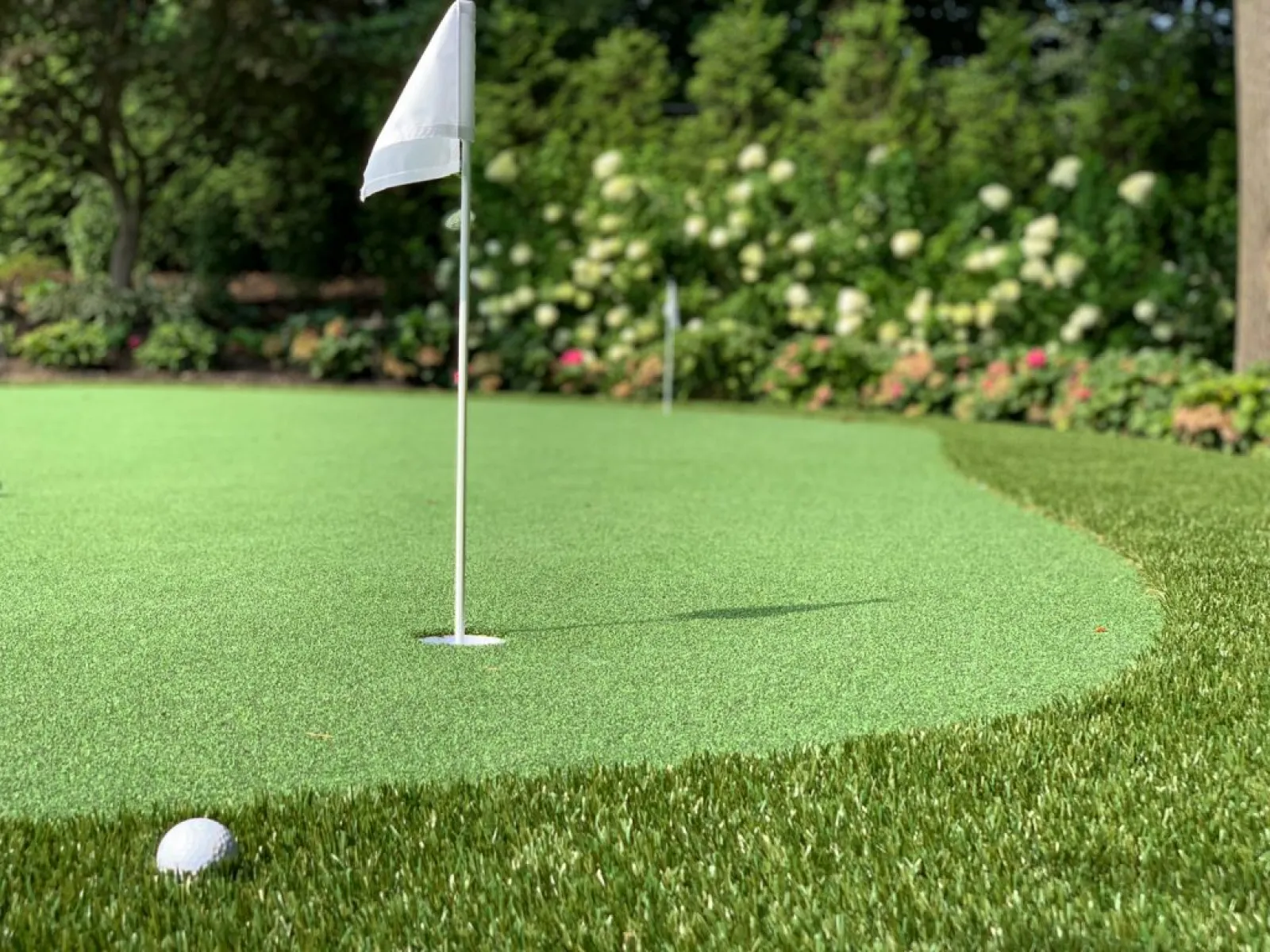 a golf ball on a green golf course