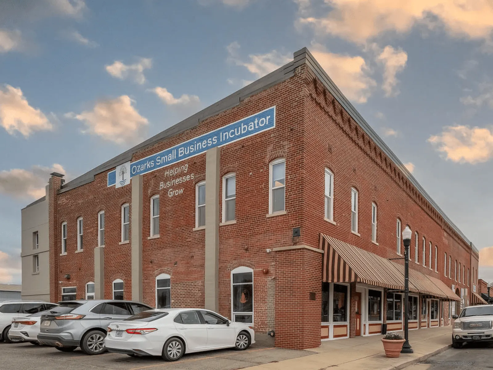 a brick building with cars parked in front of it
