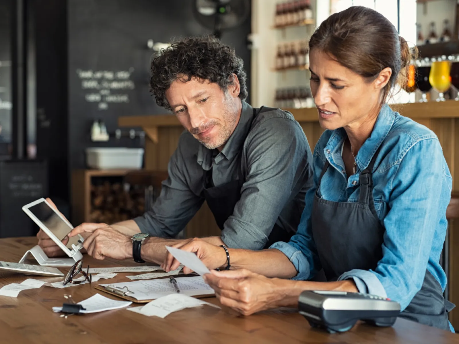 a man and a woman looking at a tablet