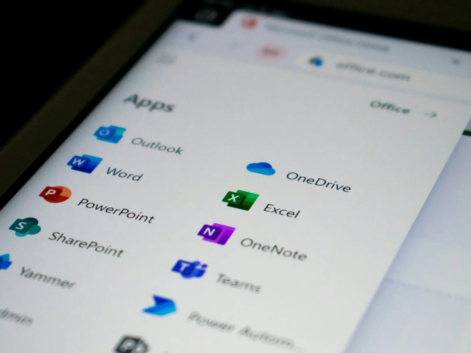 Screen showing Microsoft Office apps including Word, Excel, PowerPoint, OneDrive, Teams, and OneNote icons.