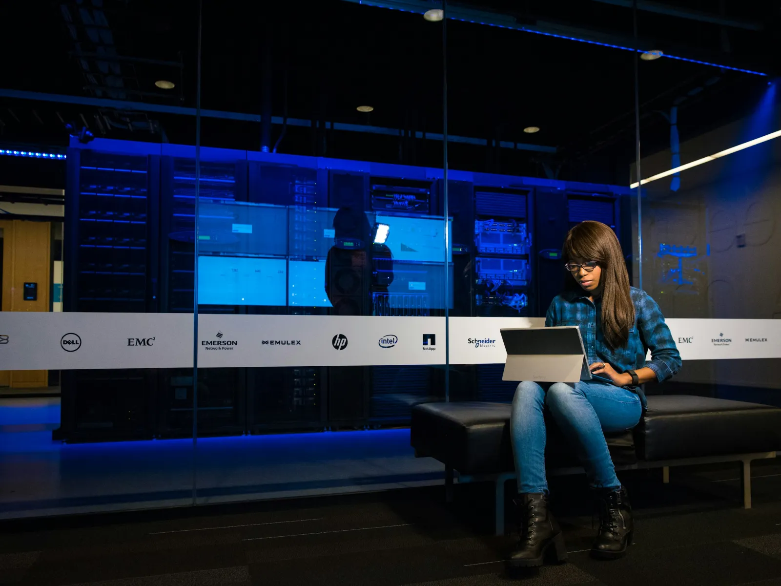 a person sitting on a bench with a laptop
