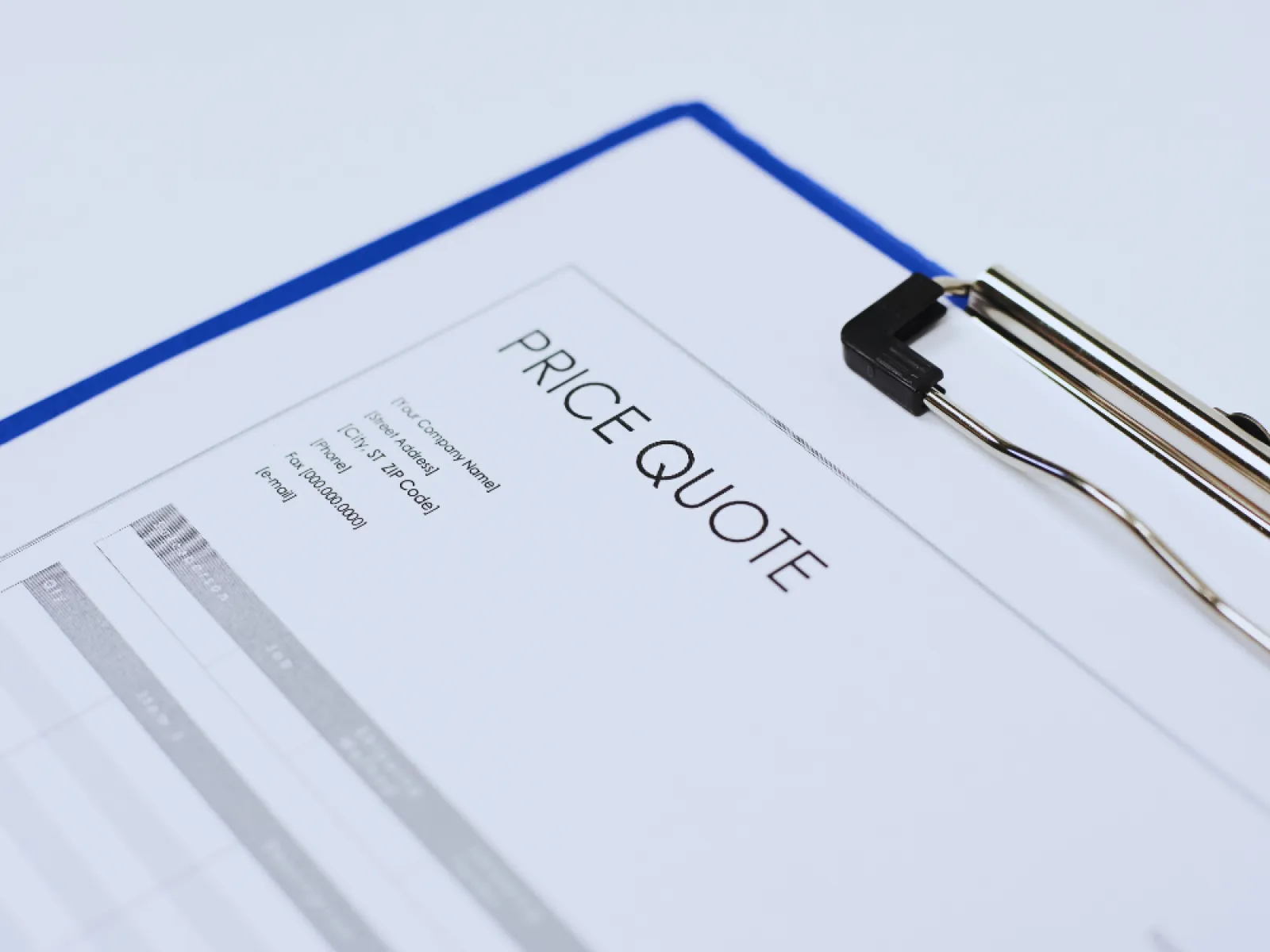 Close-up of a price quote document clipped on a blue clipboard with a white background.