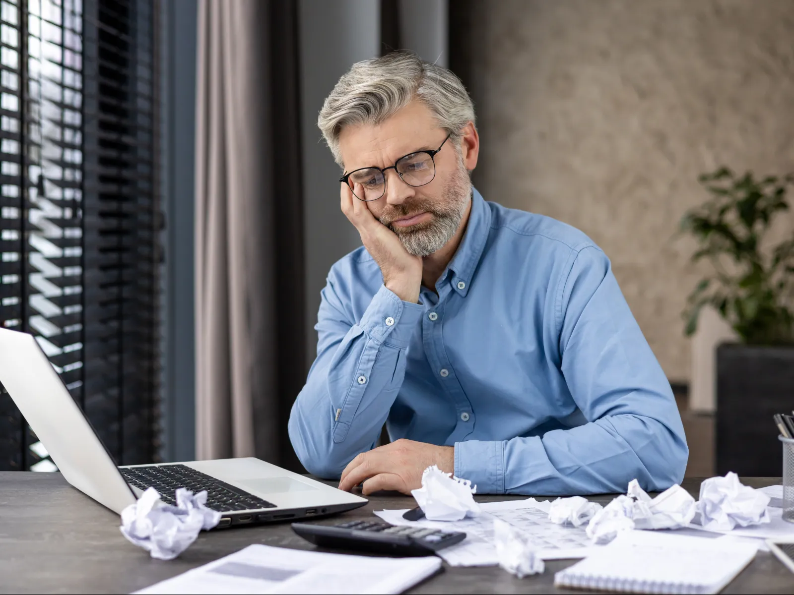 a man sitting at a table with a laptop