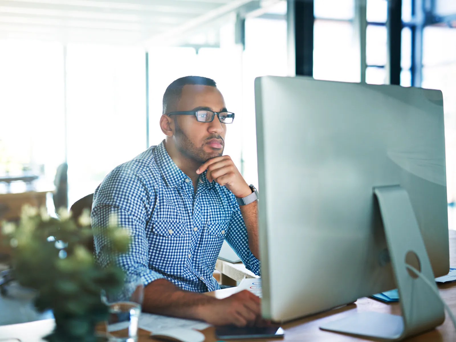 a person sitting at a desk with a computer