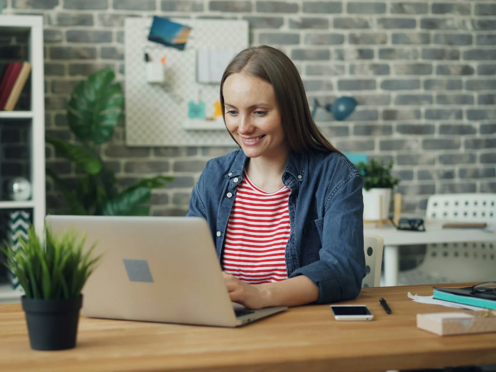 a person sitting at a desk with a laptop