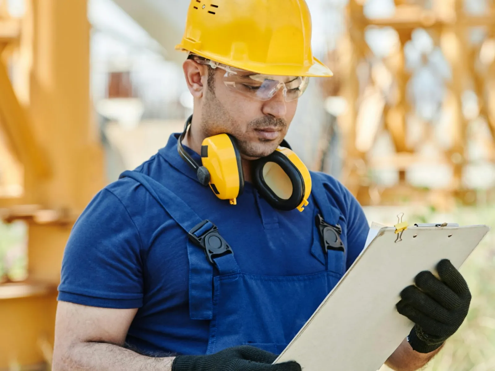 a person wearing a hard hat and holding a piece of paper