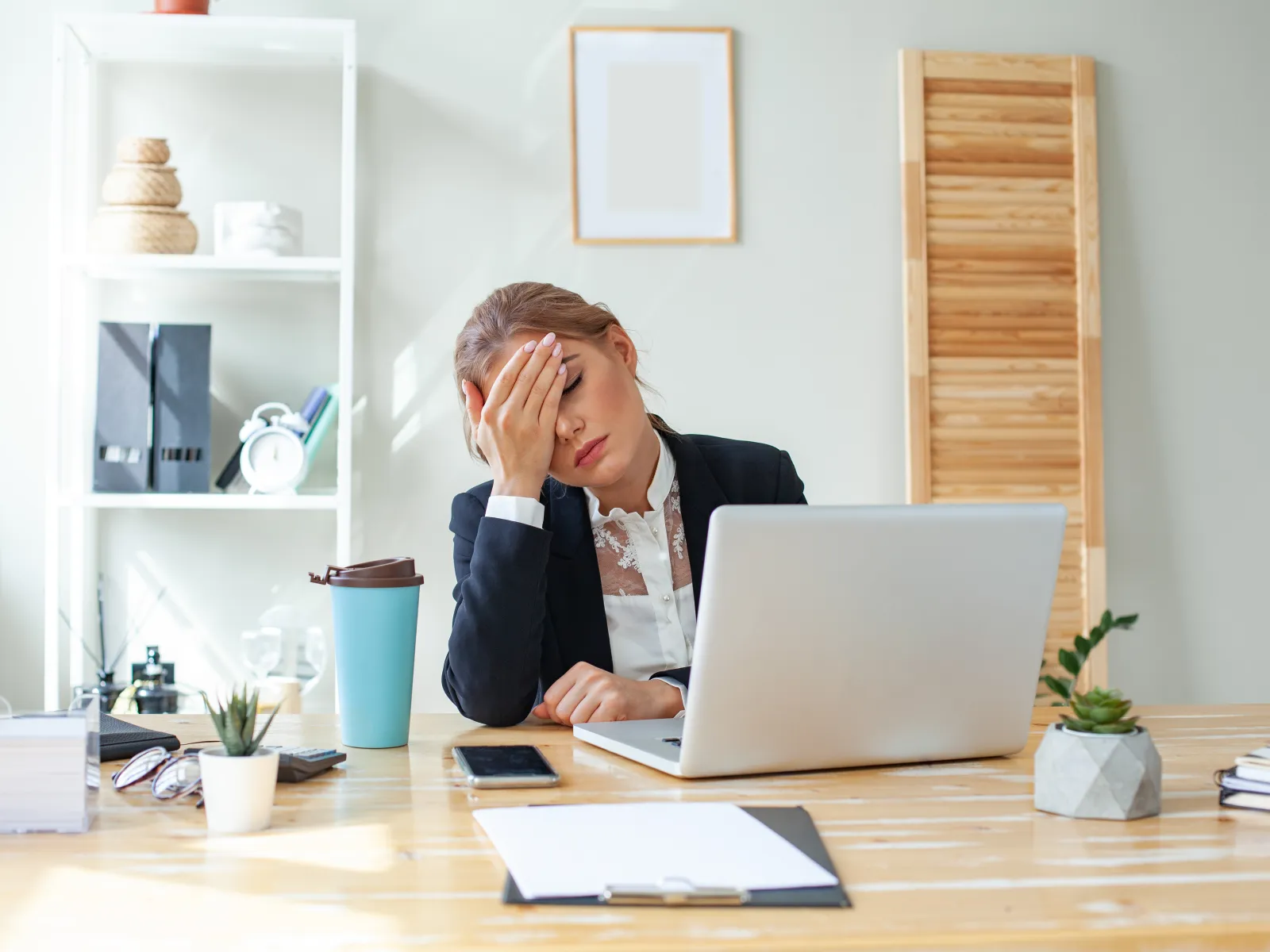 a person sitting at a desk with a laptop