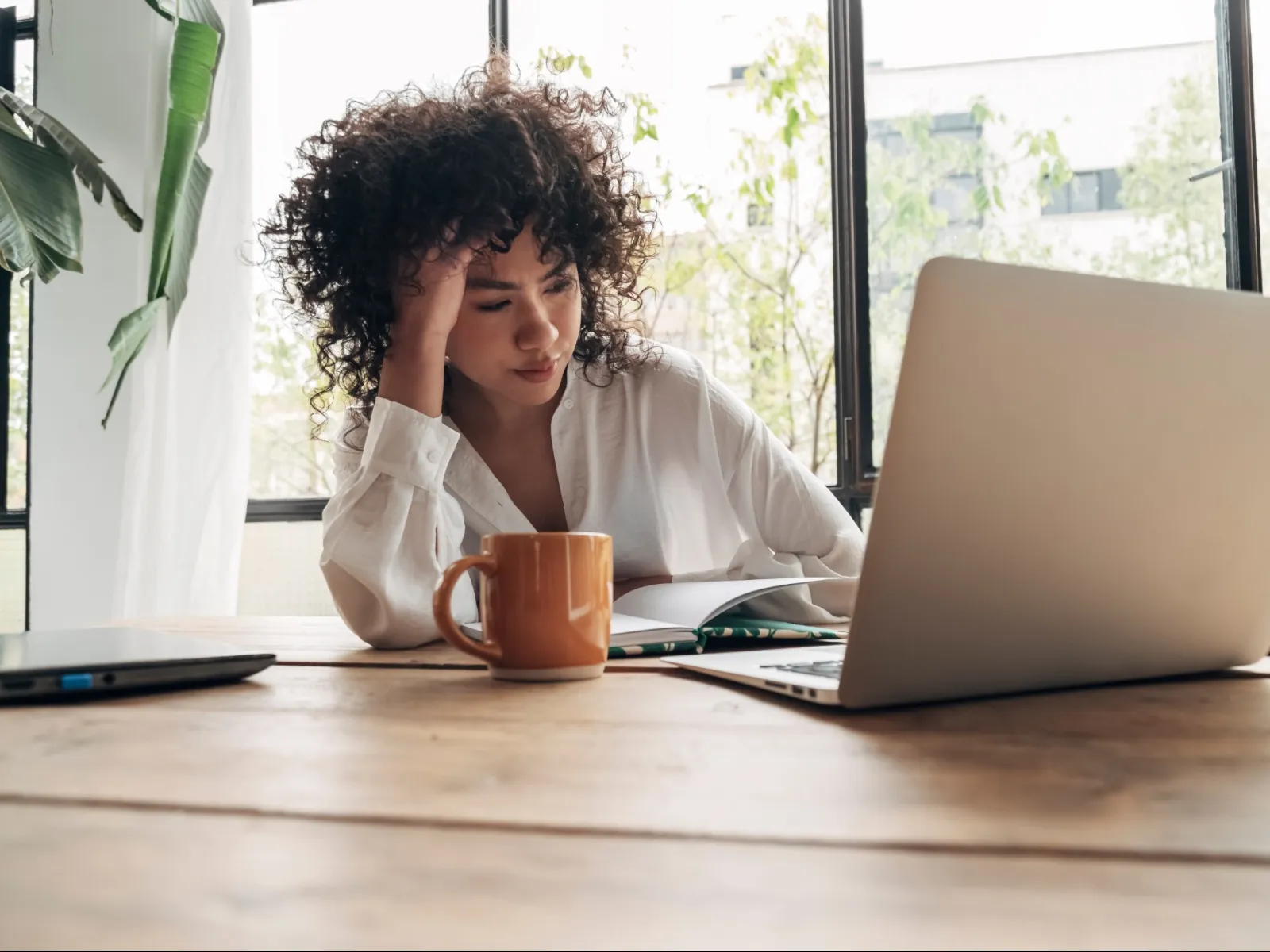 a person sitting at a desk with a laptop