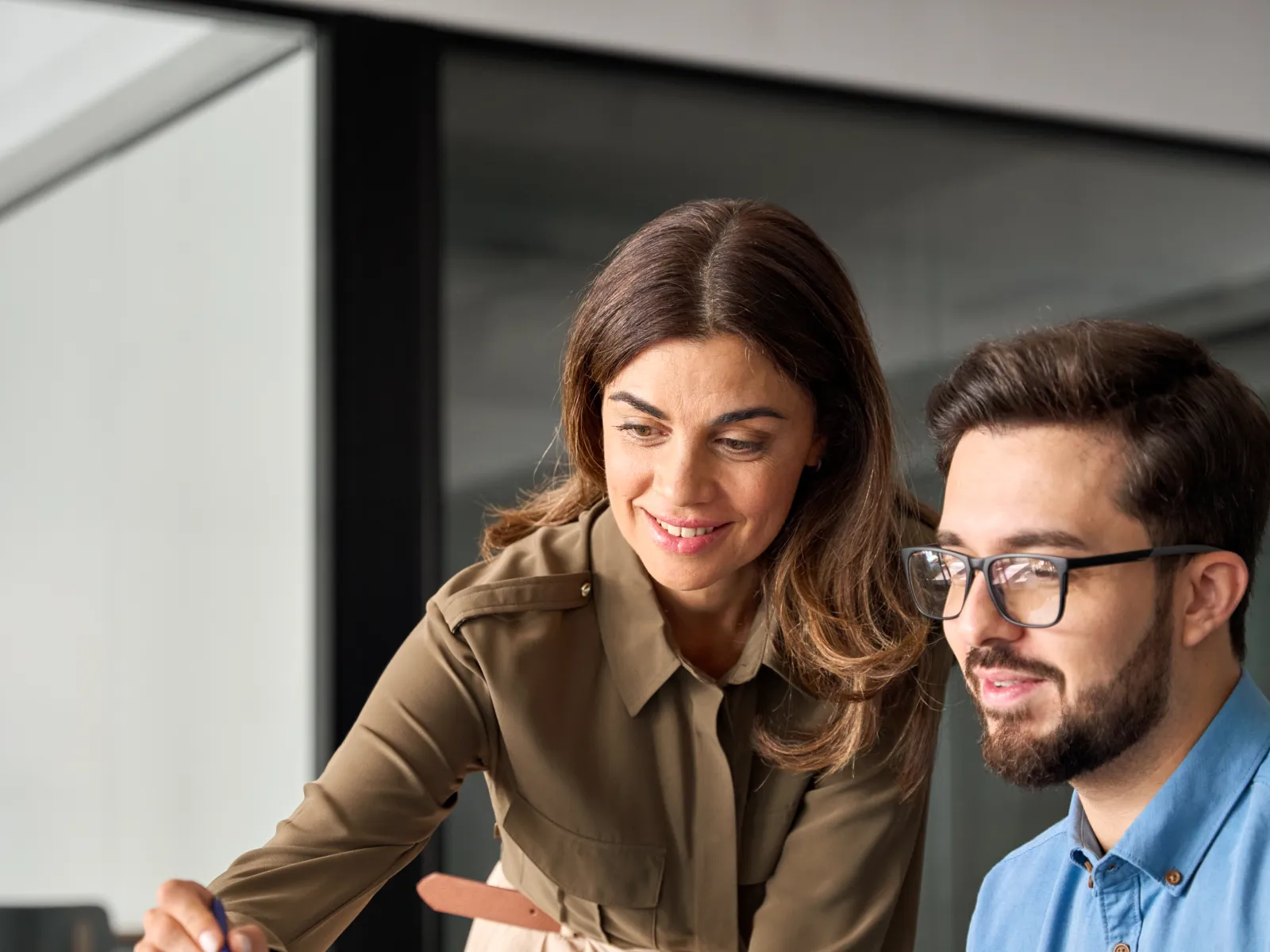 a man and a woman looking at a laptop