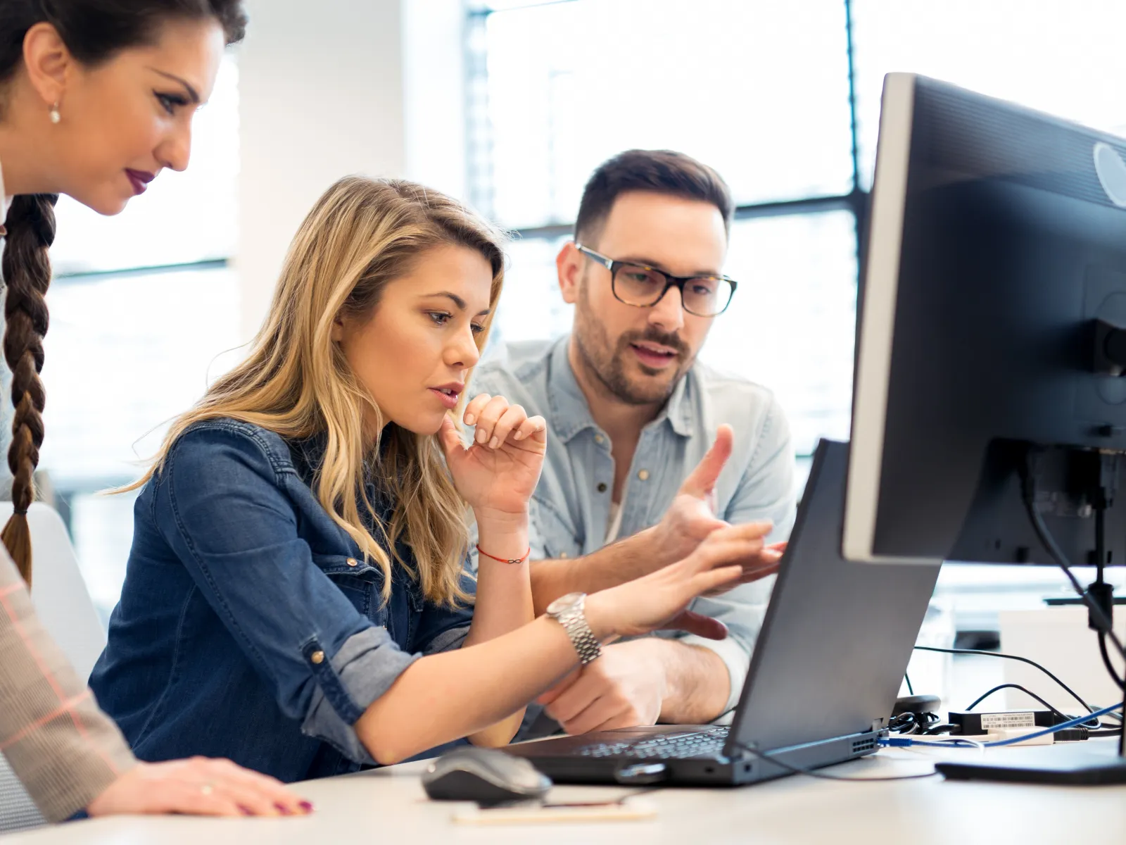 a group of people looking at a computer screen