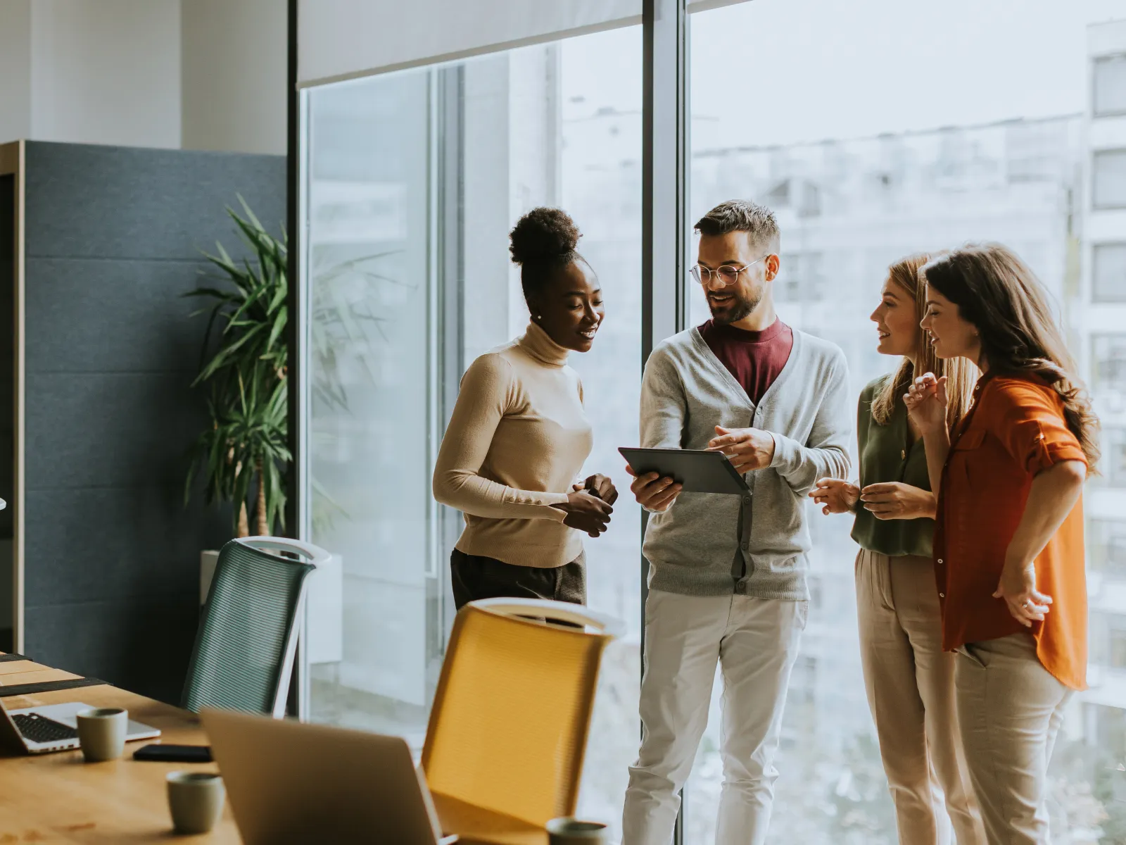 a group of people talking in an office