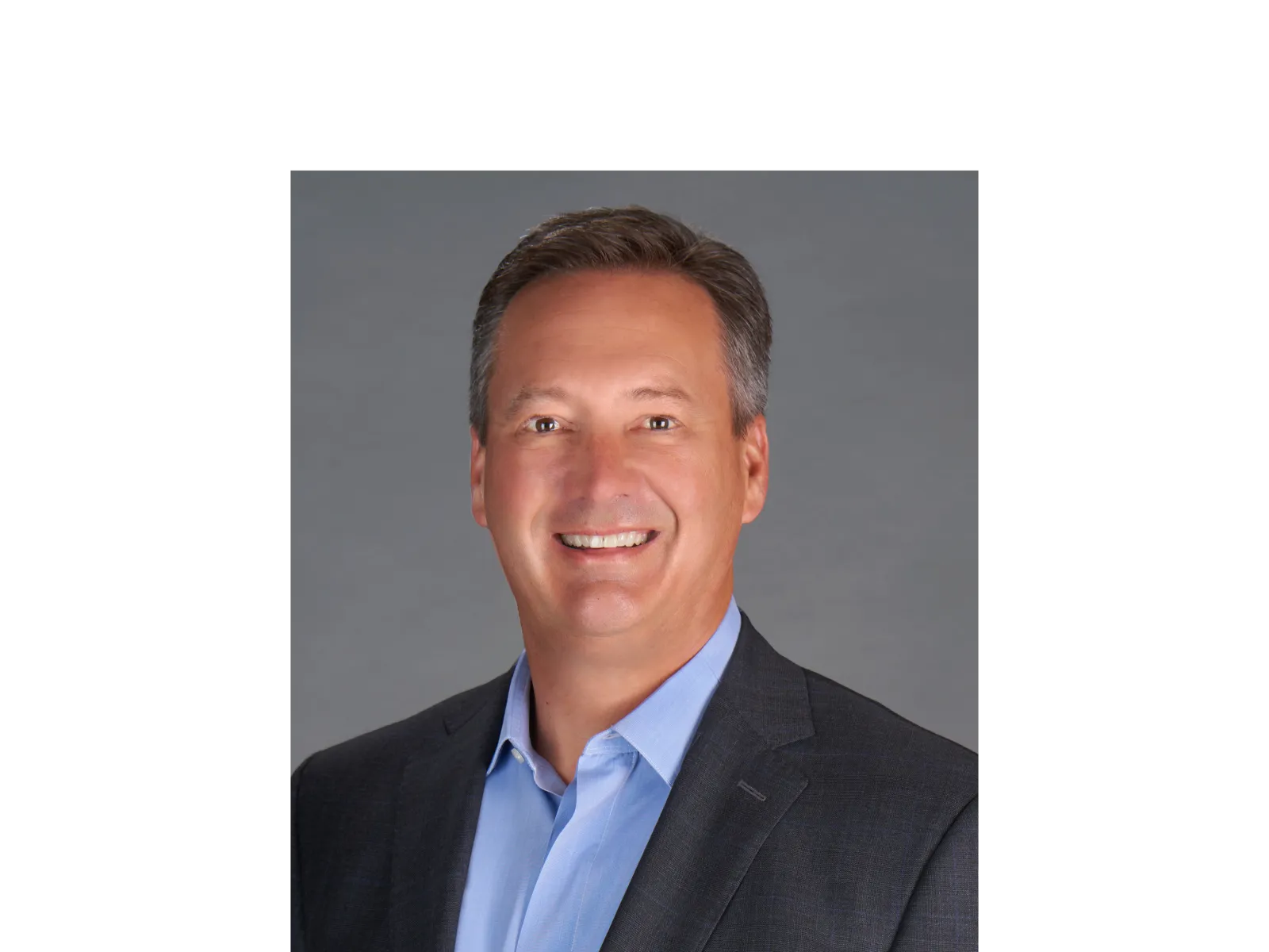 a man in a suit smiling
