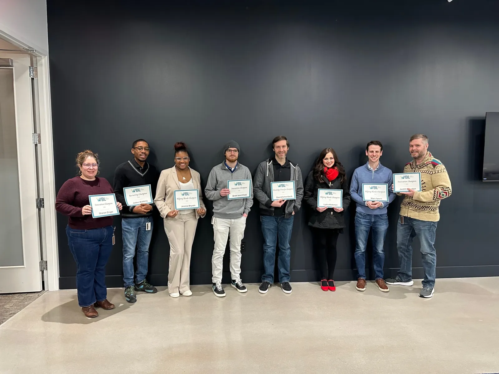 a group of people holding certificates