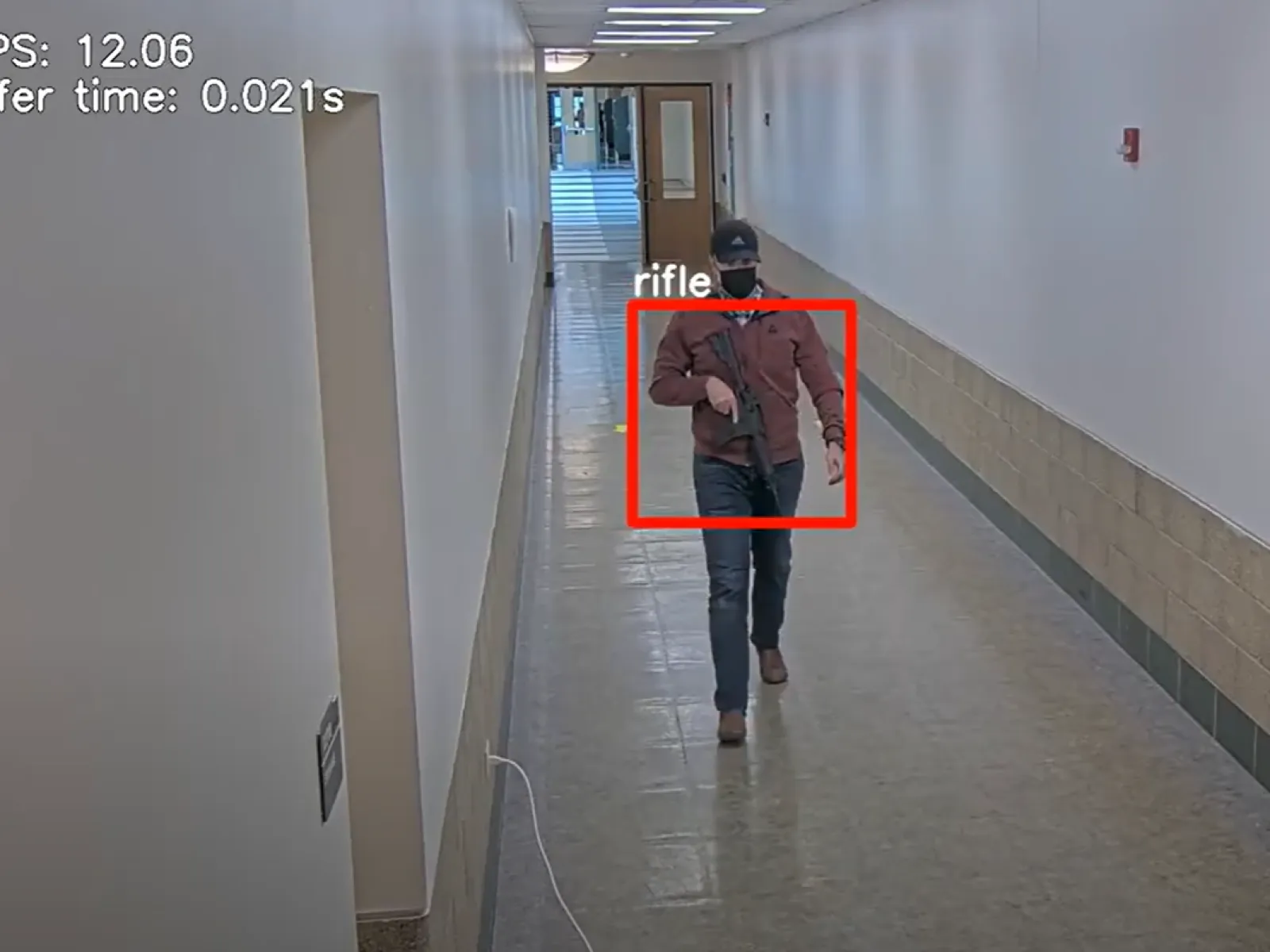 a person in a garment walking down a hallway