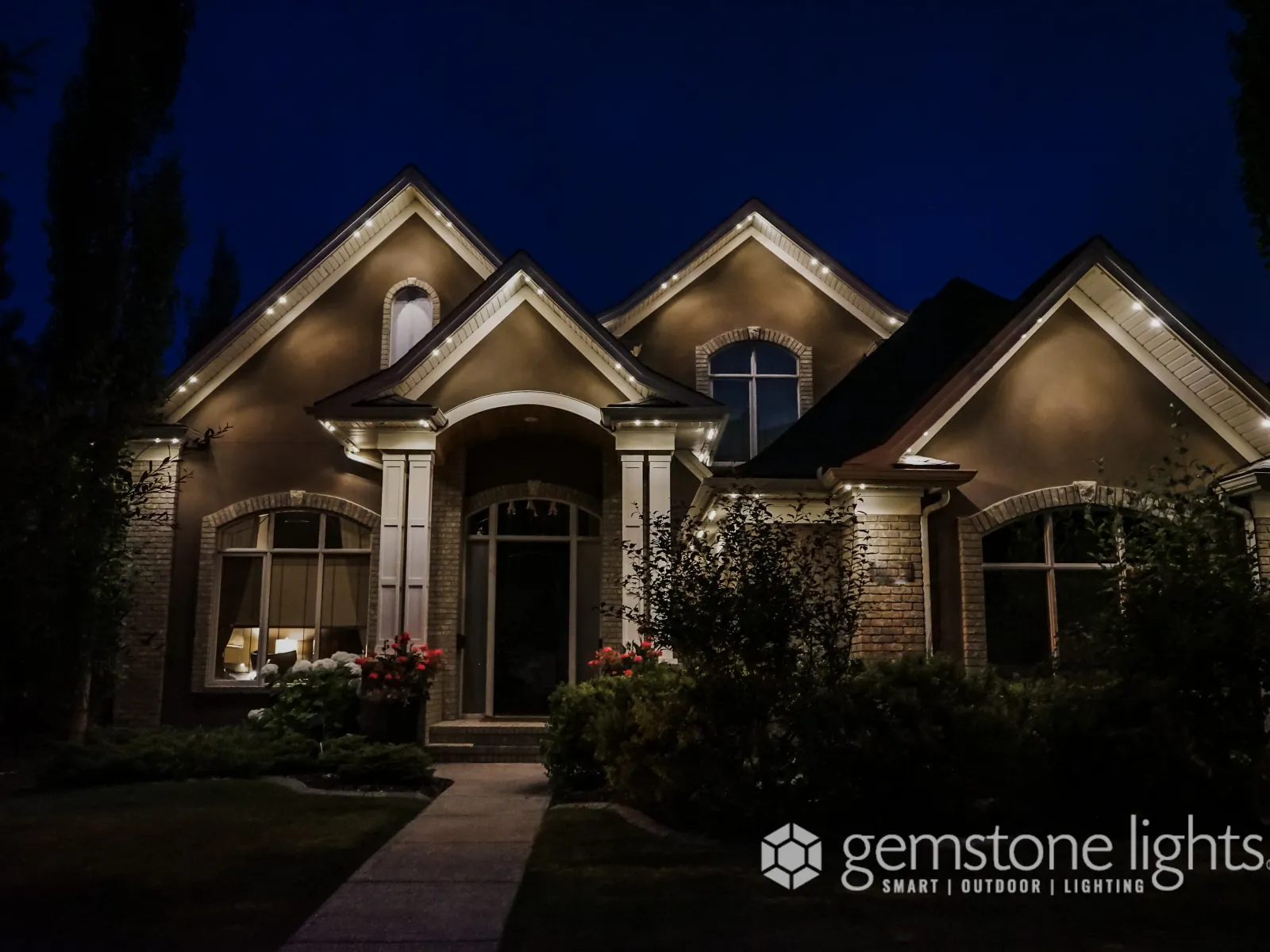 a large brick house with a front yard and a brick driveway