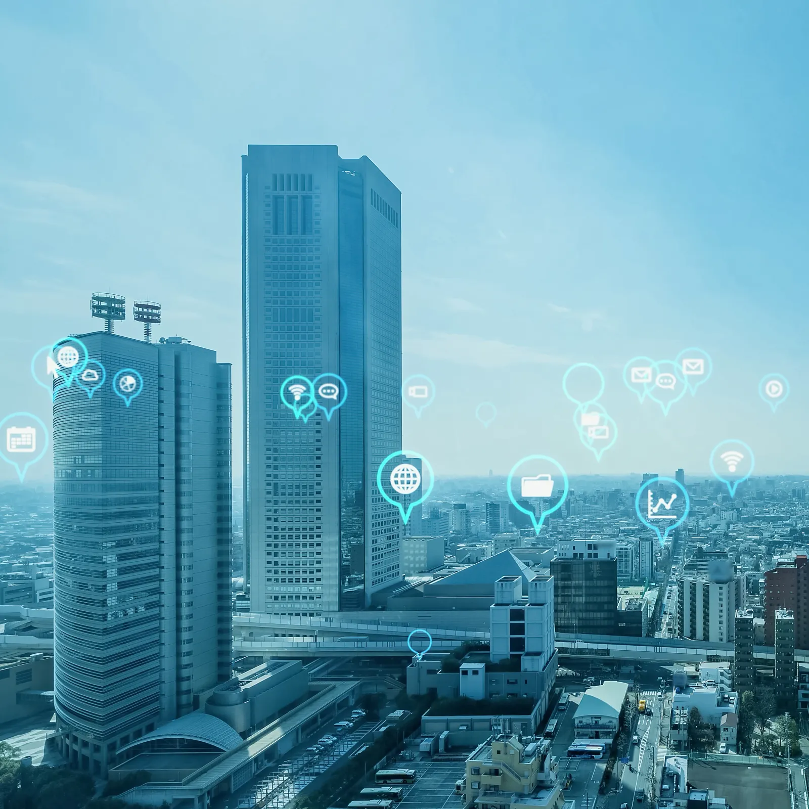 A city skyline with digital connection icons representing technology and communication.