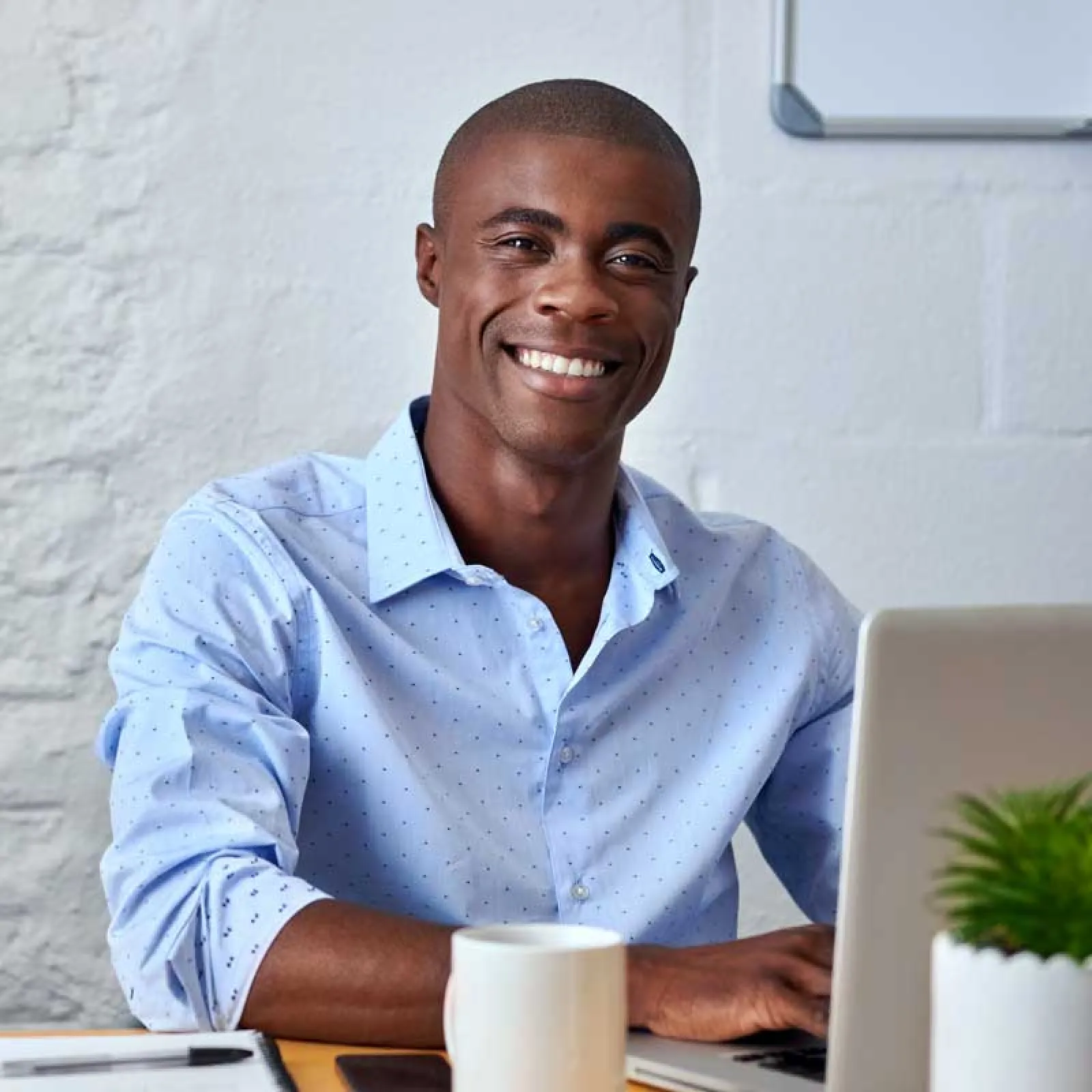 Jeremie Boga smiling and sitting at a table