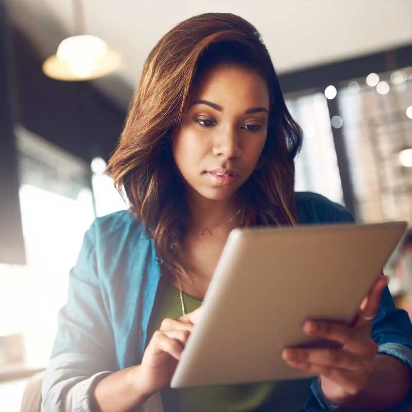 a woman looking at a tablet