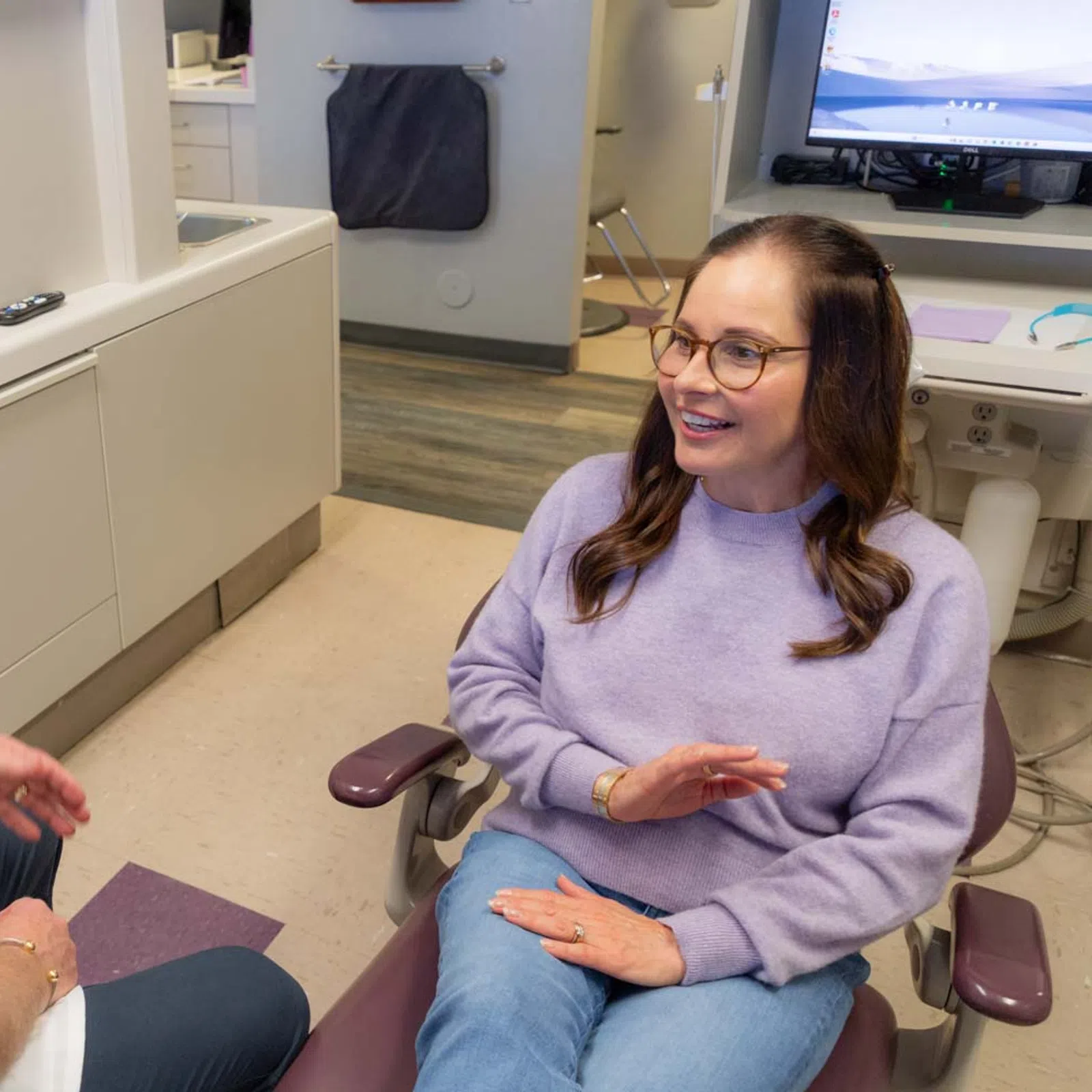 Dentist consulting a female patient in a dental office during a check-up appointment