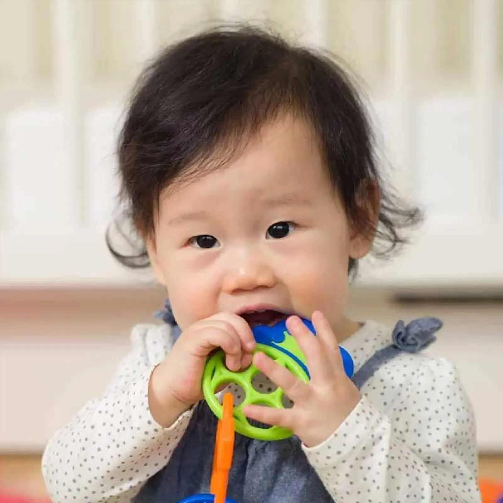 a baby holding a toy