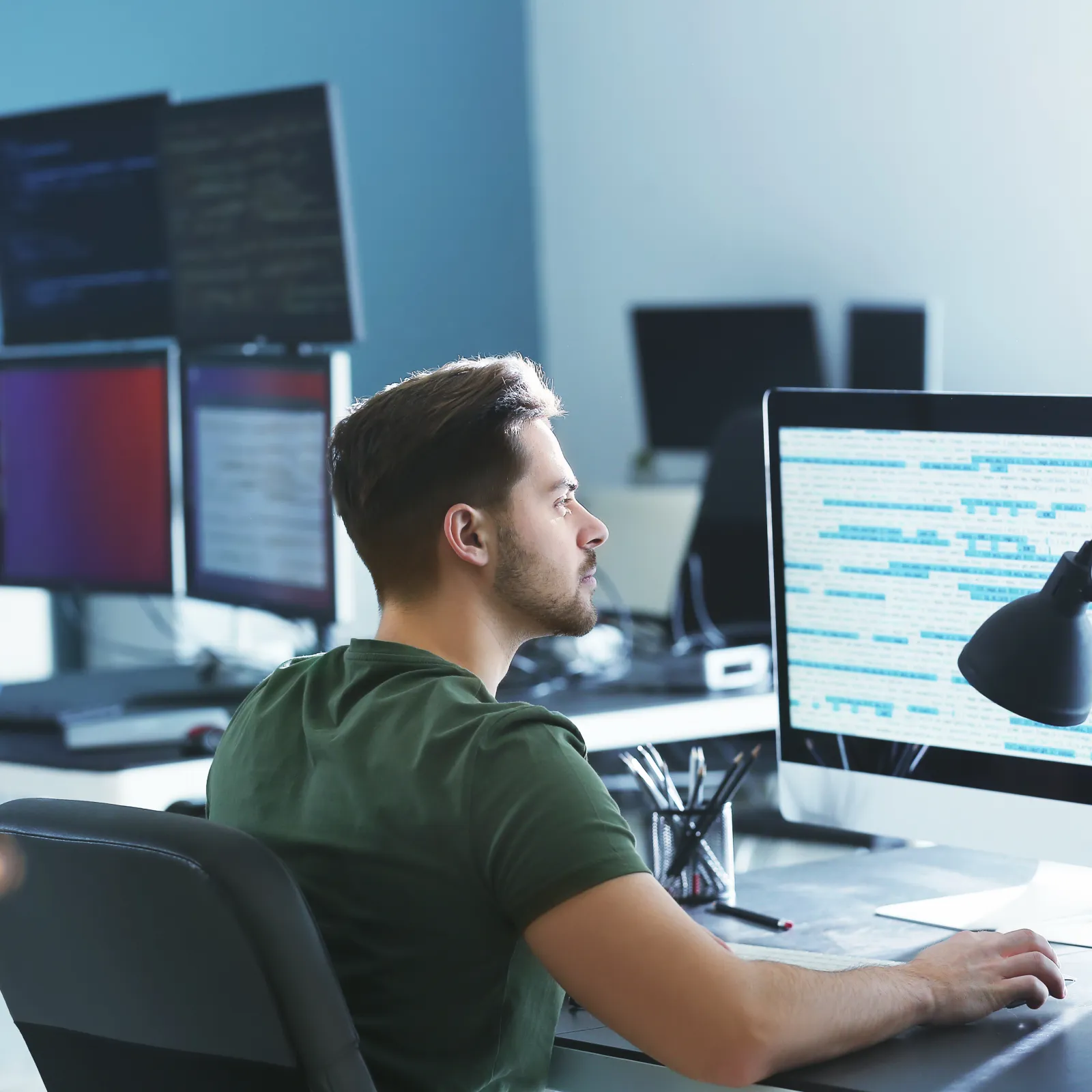 a person sitting at a desk with a computer