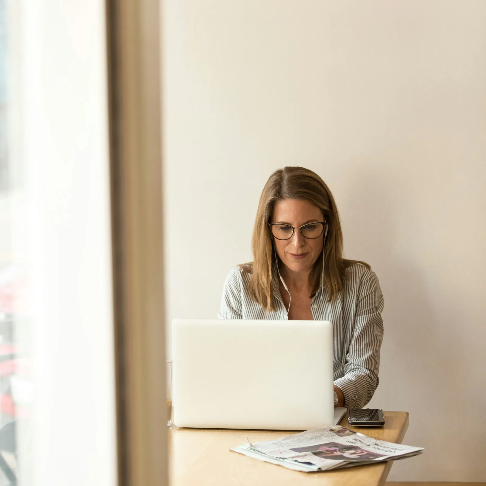 a person sitting at a desk with a laptop