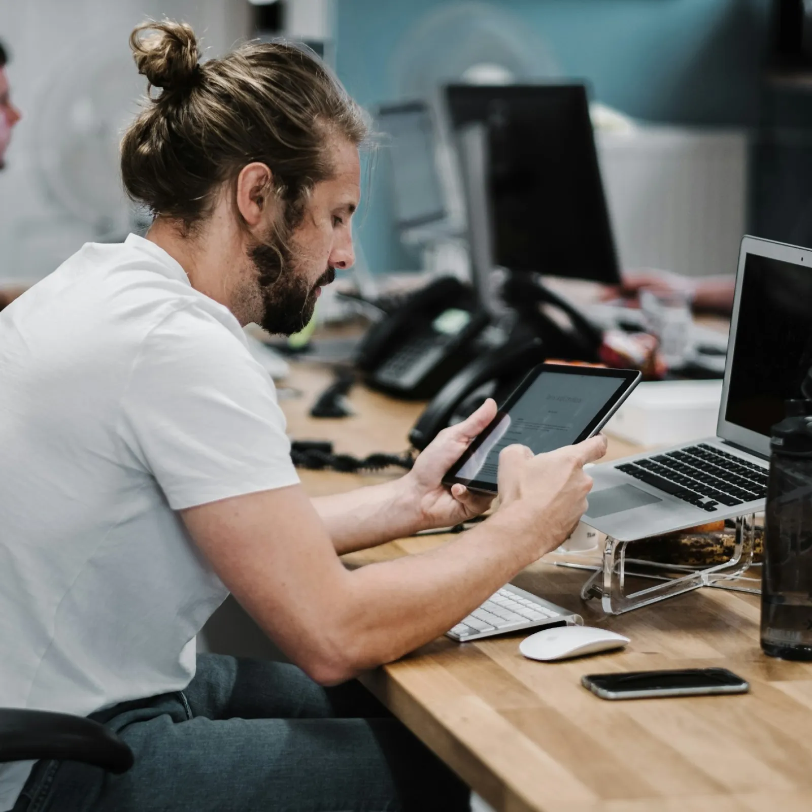 a man sitting at a desk using a laptop