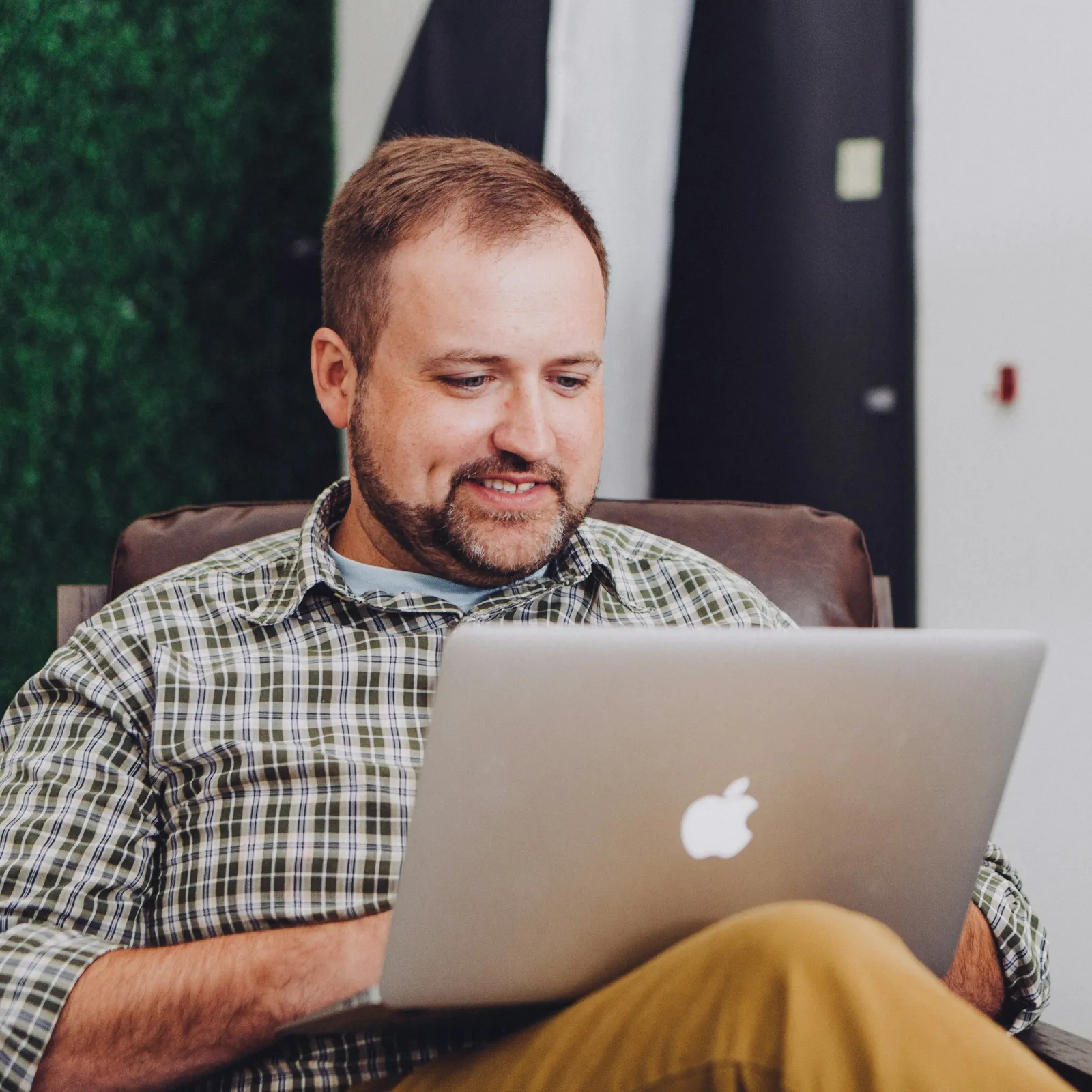 a man sitting in front of a laptop