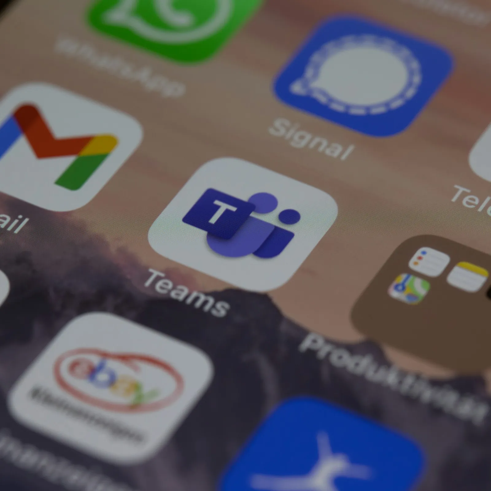 Close-up of mobile app icons including Microsoft Teams, Gmail, and Telegram on a smartphone screen.