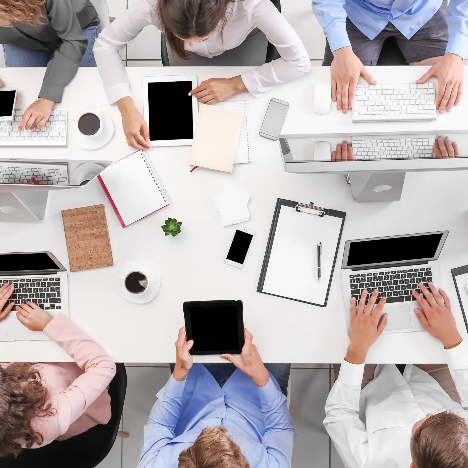 a group of people working on laptops