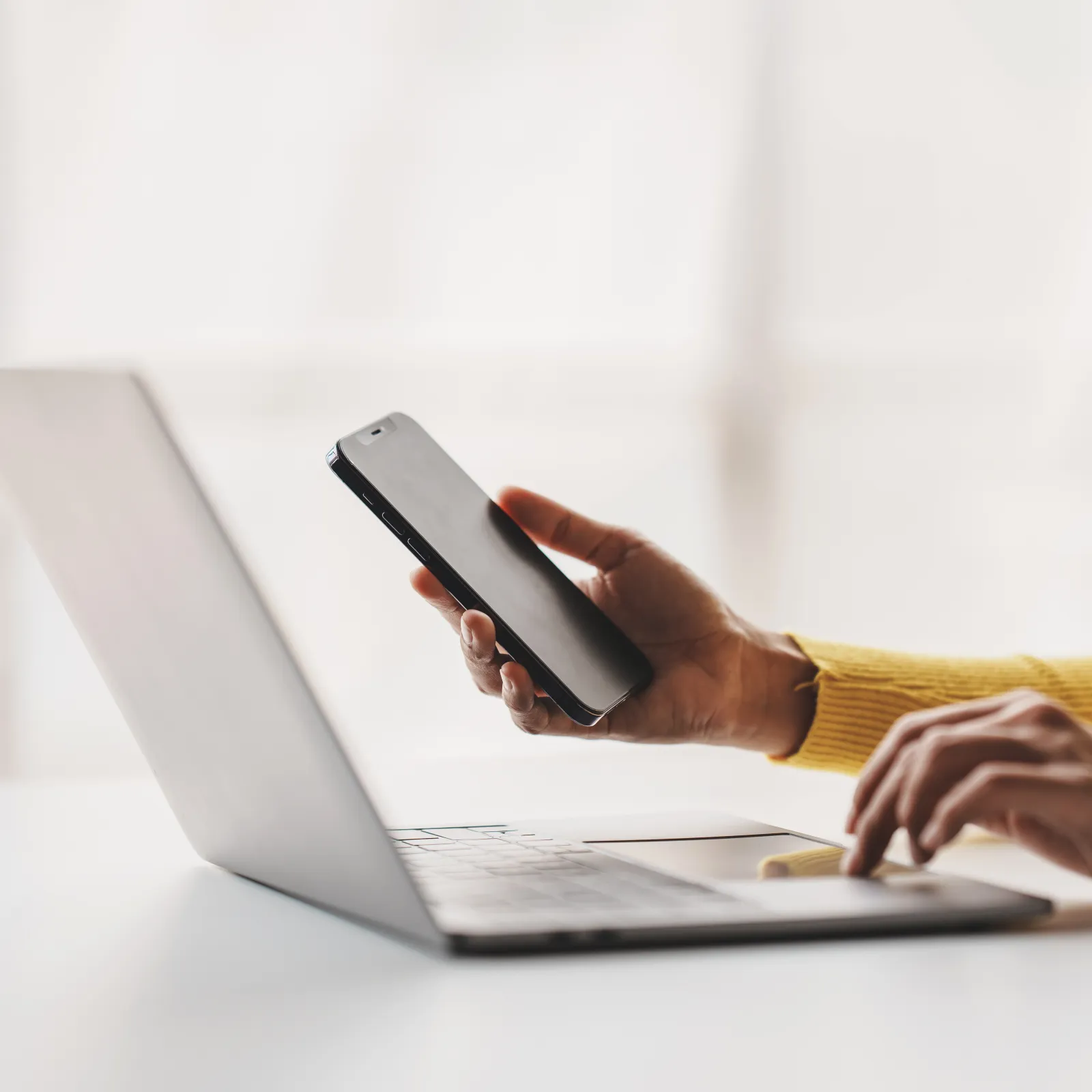 a woman sitting at a table with a laptop