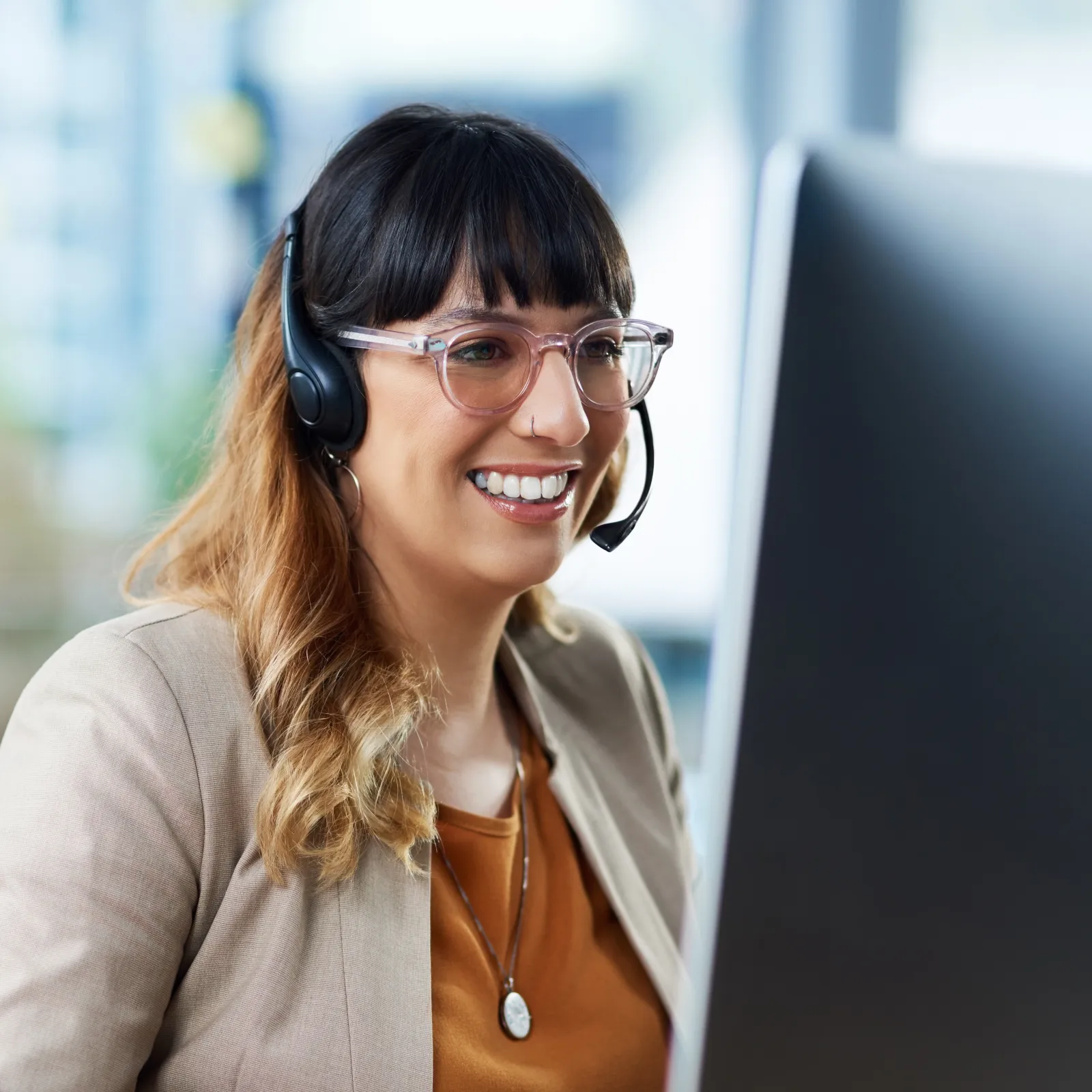 a woman wearing glasses and smiling