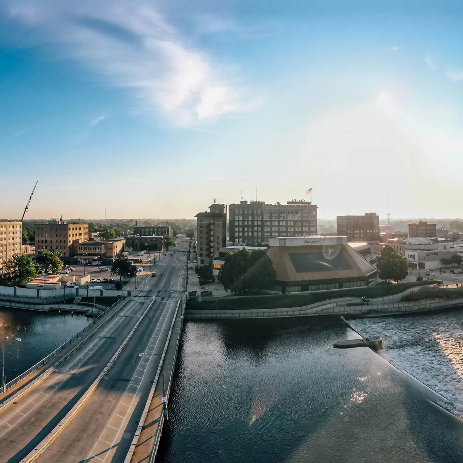 a river with a bridge and buildings along it