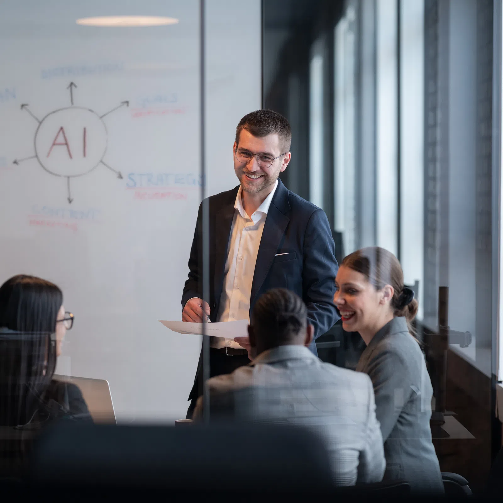 Business team discussing AI strategy in a modern office with whiteboard and natural light during meeting.
