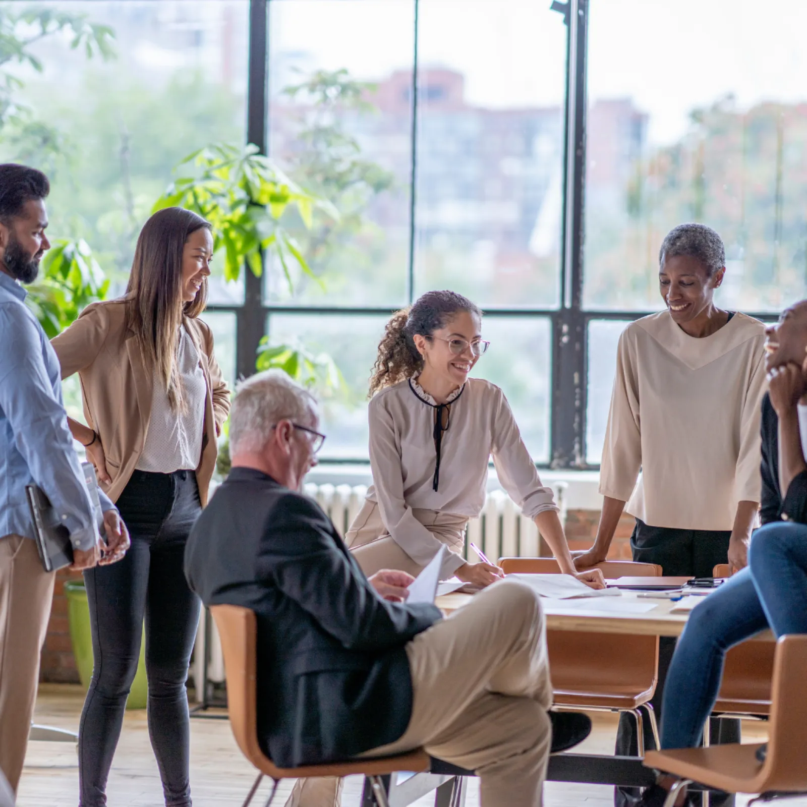 a group of people standing around a table