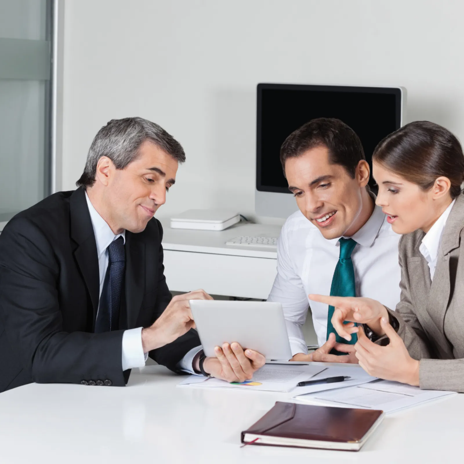 Demian Costas et al. looking at a tablet