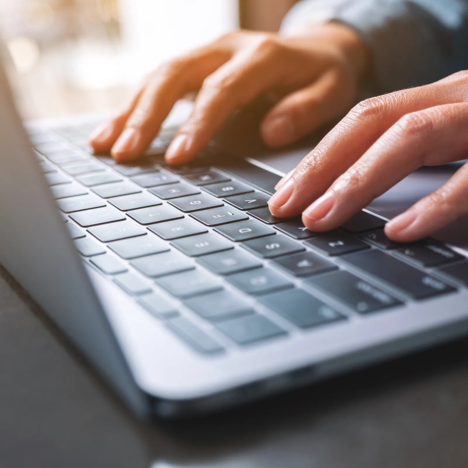 a person typing on a laptop
