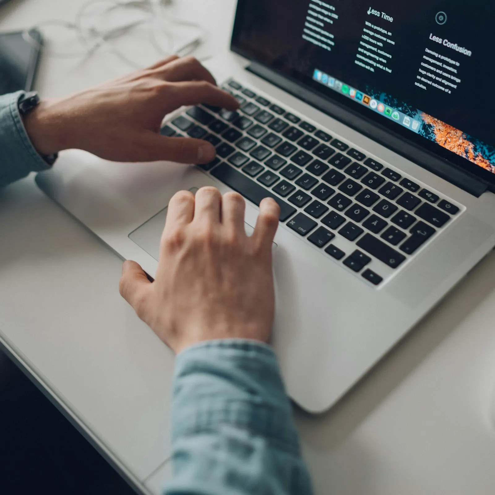 a few hands on a laptop