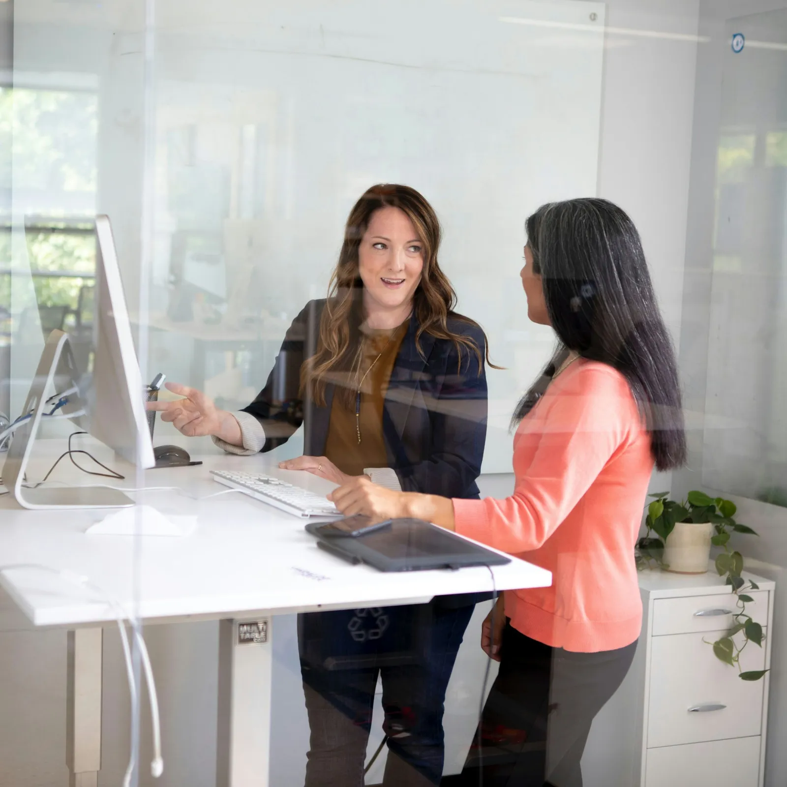 a few women looking at a laptop