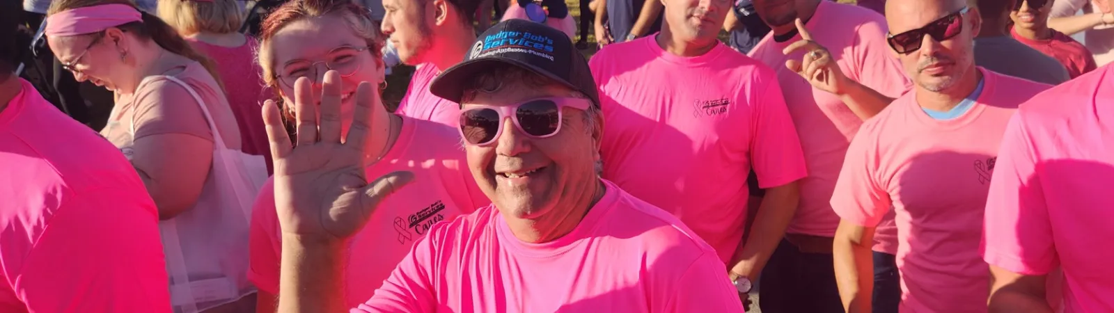 a group of people wearing pink shirts